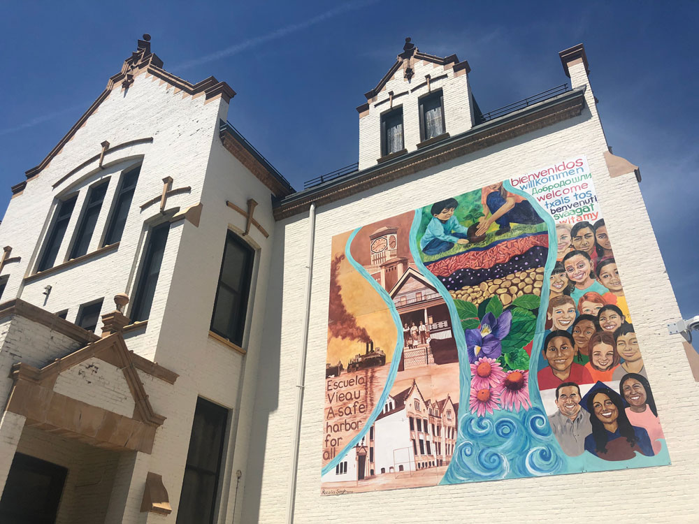 A colorful mural on the outside of a school building