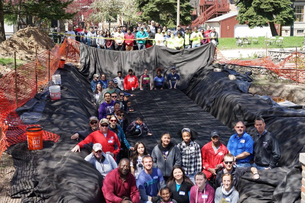 Volunteers gather outside at the Paliafito Eco-Arts Park as part of the Paliafito Cistern build team